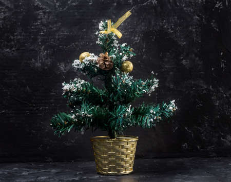 small christmas tree on black abstract background.