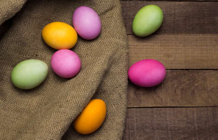 beautiful easter eggs on burlap, on a rustic background flat lay.の写真素材