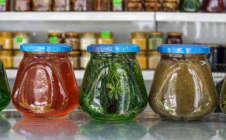 several jars with various exotic jams on the background of the counter.
