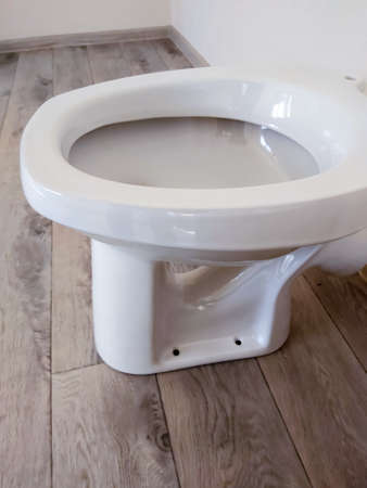 new white toilet bowl in the bathroom side view.の写真素材