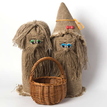 two Russian toy brownies with a basket, on a white background.