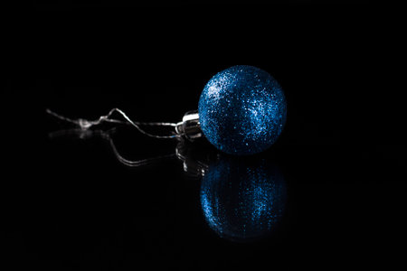 one blue christmas toy on a black backgroundの写真素材