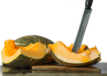 green but ripe butchered pumpkin on a white backgroundの写真素材