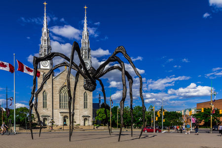 Maman spider sculpture on the Basilica church background, Ontario, Canadaのeditorial素材