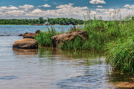 An amazing landcape of the nature containing a lake and a beautiful blue sky. The wild nature of Ontario, Canada.の写真素材