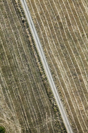 Aerial view over agricultural fields and road