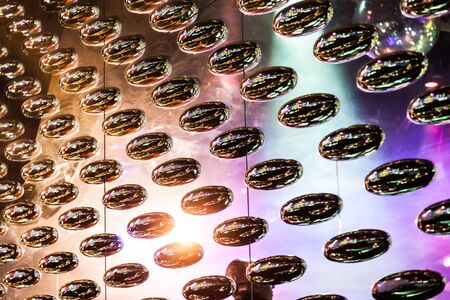 Real metal rolling oval mirrored light as abstract background.