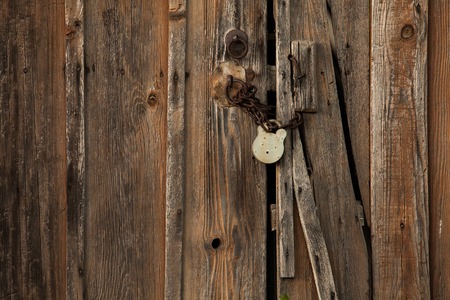 Old padlock on a old wooden doorの写真素材