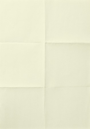 Yellow sheet of paper folded in sixの写真素材