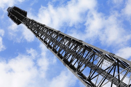Stadium lights hung and suspended on a large metal structure, during the daytime so the lights are...