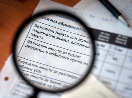 Magnifying glass over a newspaper Bulgarian word free business