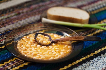 Garlic, bread, beans on a colorful rug Bulgarian, selective focusの写真素材