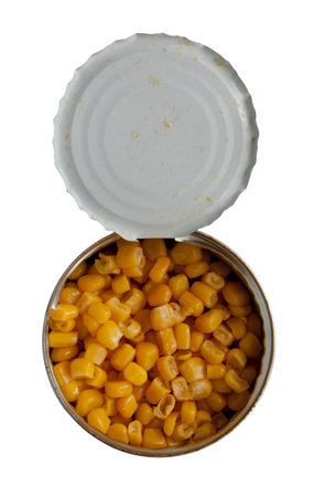 Opened cans of corn.  Iron packaging, a photo with top, isolated over whiteの写真素材