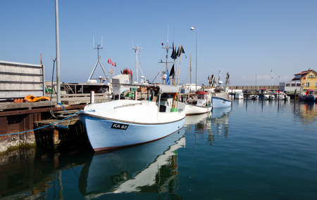 A fishing boat in a small danish harbourのeditorial素材