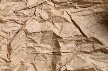 sheet of crumpled wrapping paper yellowの写真素材