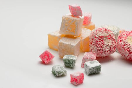 Sweets Turkish Delight, fruit jelly in coconut chips color on a white backgroundの写真素材