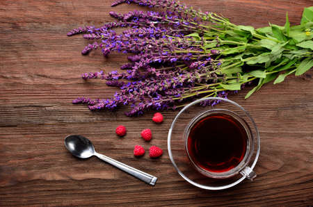 raspberry with cornflowers on wooden background. still life. The concept of summer light breakfast. Still life with raspberries and chocolateの写真素材