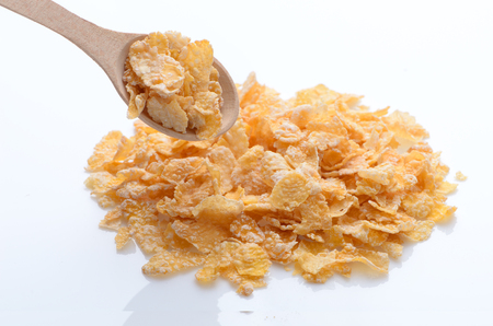 bowl of cornflakes with a spoon on white background. Healthy Eating. breakfast. vegetarianism.の写真素材