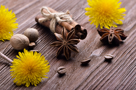 spices from coffee beans and flowers on the wooden backgroundの写真素材