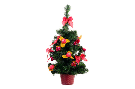 Christmas fir tree isolated on a white background with ribbons, bells and ballsの写真素材