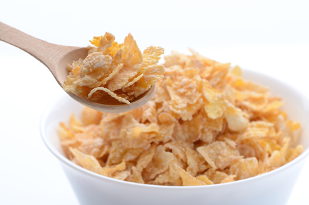 bowl of cornflakes with a spoon on white background. Healthy Eating. breakfast. vegetarianism.の写真素材