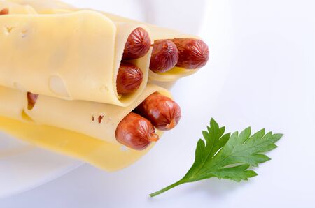 sausages with cheese and parsley on a plateの写真素材