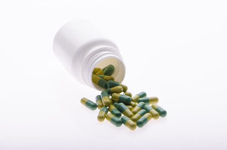 Container with green pillsの写真素材