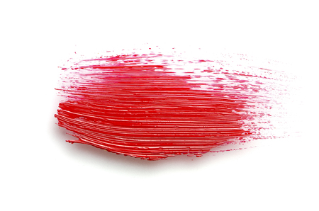 Red paint stroke with oil paint on white backgroundの写真素材