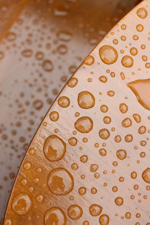 Raindrops pattern on wooden deck close upの写真素材