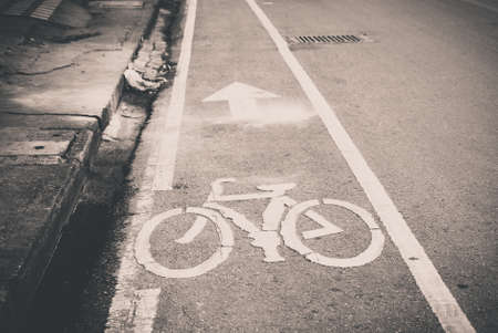 Black and white of urban road with bicycle lane symbol