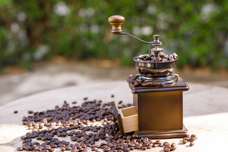 A coffee grinder and coffee beans with natural lightの写真素材