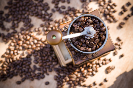 A coffee grinder and coffee beans with natural lightの写真素材