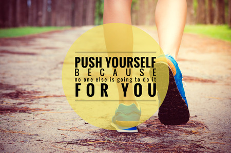 Inspirational quote on legs running through pine tree forest trail,の写真素材