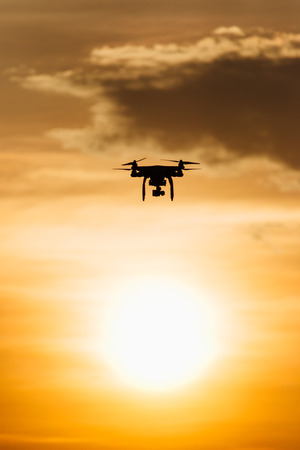 A drone fly over sunset with warm color in siloutte sceneの写真素材