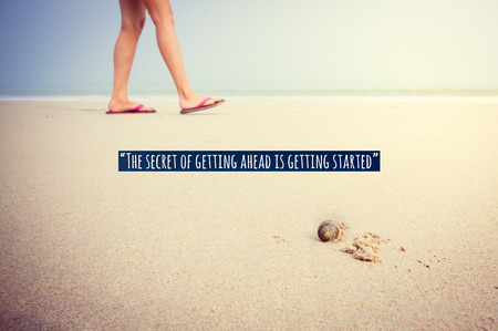 Inspirational quote on girl feet walking on sand back behind hermit crab walking forward show...