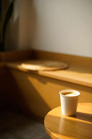 Coffee cup on wooden table in coffee shop, stock photoの写真素材