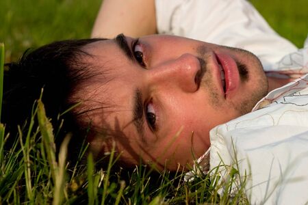 Portrait of Young Man relaxing on the grass