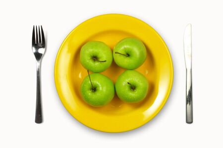 Granny Smith Apple on yellow plateの写真素材