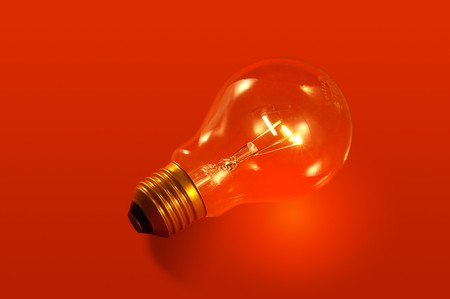 Red background with lightbulbの写真素材