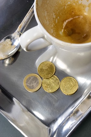 Empty coffee cup with euro coinsの写真素材