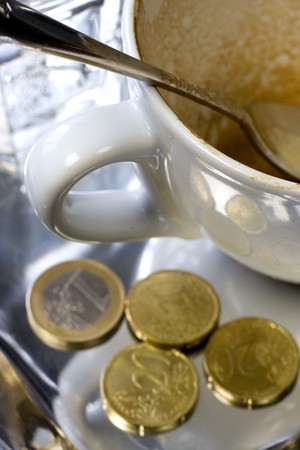 Empty coffee cup with euro coinsの写真素材