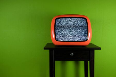 Red old retro television on green roomの写真素材