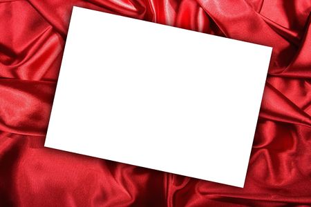 Blank white card on red colored satin clothの写真素材