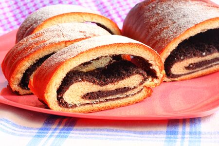 Poppy seed strudel on a plate sprinkled with sugarの写真素材