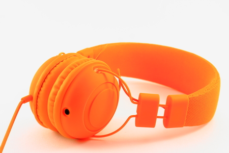 Big orange headphones on a light backgroundの写真素材