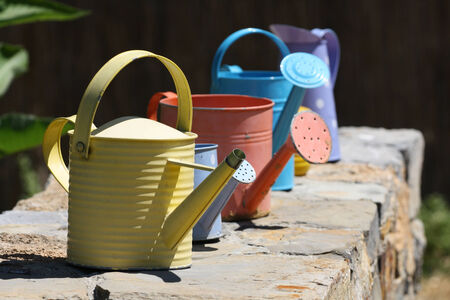 Color watering can on wallの写真素材