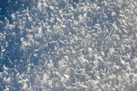 Close-up of snow crystals on the surface of the lake. Detail of ice crystals