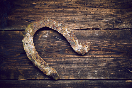 Old rusty horseshoe on vintage wooden boardsの写真素材