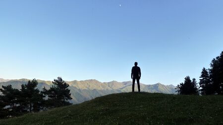 A backpacker watching magical sunset in Tusheti, Omalo, Georgiaの写真素材