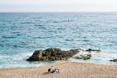 Sea rocks and waves in beautiful sunny dayの写真素材